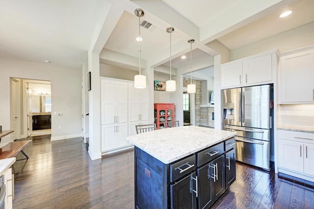 3105 Mccurdy St, Austin, TX 78723 - kitchen featuring stainless steel fridge, white cabinets, dark wood-style flooring, pendant lighting, and recessed lighting