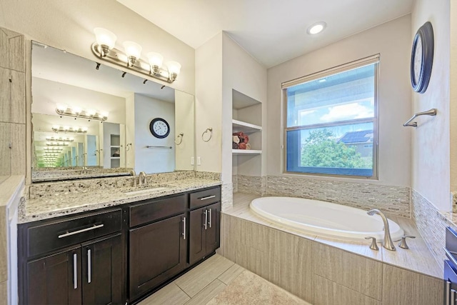 3105 Mccurdy St, Austin, TX 78723 - full bathroom featuring a garden tub, vanity, and tile patterned flooring