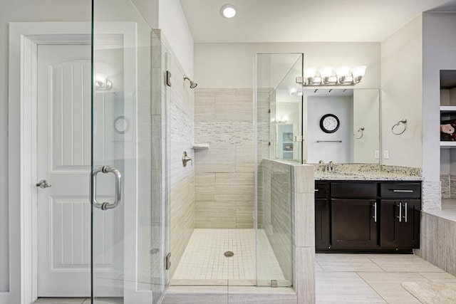 3105 Mccurdy St, Austin, TX 78723 - bathroom with a shower stall, vanity, and tile patterned floors