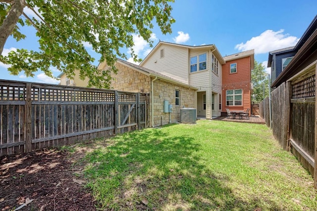 3105 Mccurdy St, Austin, TX 78723 - rear view of house featuring stone siding, a fenced backyard, and a patio area