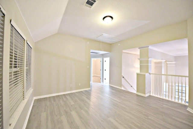1933 Chasewood Dr, Austin, TX 78727 - unfurnished room with attic access, wood finished floors, and lofted ceiling