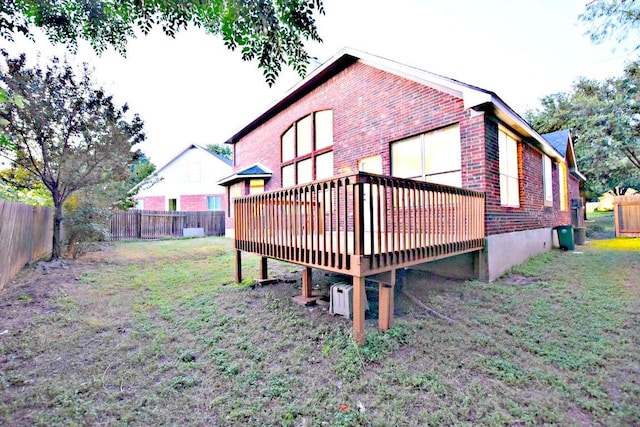 1933 Chasewood Dr, Austin, TX 78727 - rear view of house featuring brick siding, a deck, and a fenced backyard