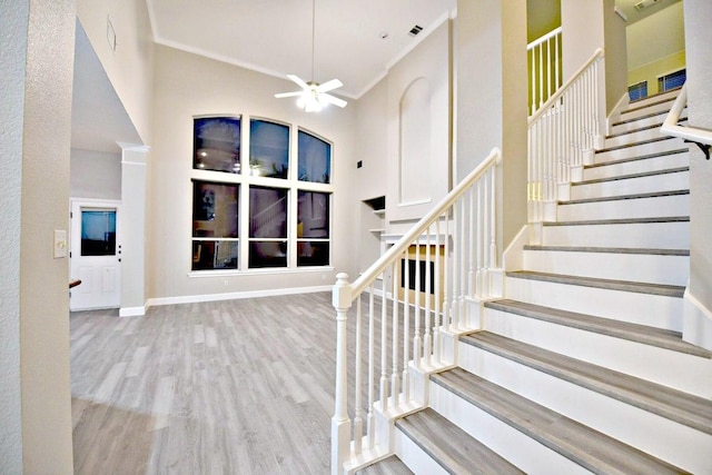 1933 Chasewood Dr, Austin, TX 78727 - stairway featuring a high ceiling, a ceiling fan, wood finished floors, and ornamental molding