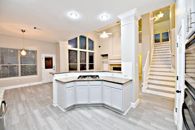 1933 Chasewood Dr, Austin, TX 78727 - kitchen featuring a ceiling fan, ornate columns, stainless steel gas cooktop, and light wood-type flooring