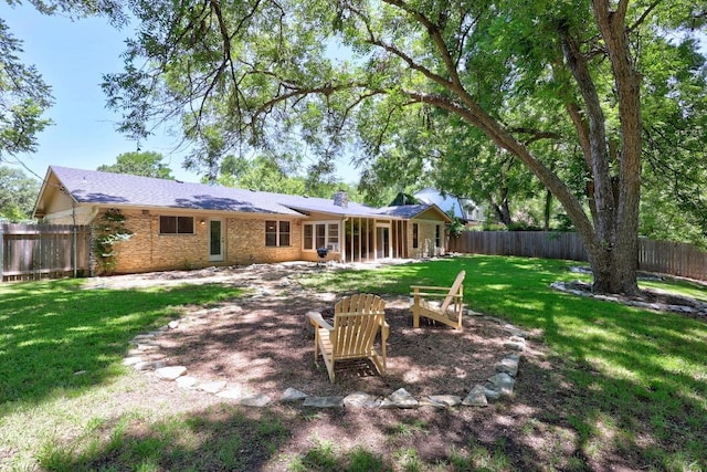 507 S Lake Creek Dr, Round Rock, TX 78681 - rear view of house featuring an outdoor fire pit, a fenced backyard, a chimney, and brick siding