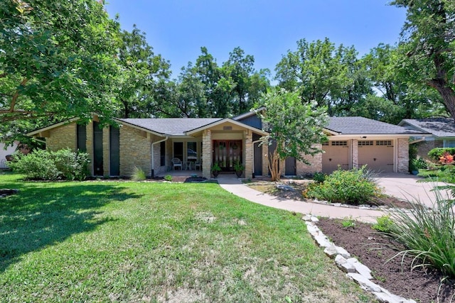 507 S Lake Creek Dr, Round Rock, TX 78681 - mid-century modern home featuring an attached garage, a front yard, concrete driveway, french doors, and stone siding