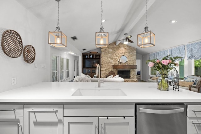 507 S Lake Creek Dr, Round Rock, TX 78681 - kitchen featuring stainless steel dishwasher, open floor plan, a fireplace, decorative light fixtures, and light countertops