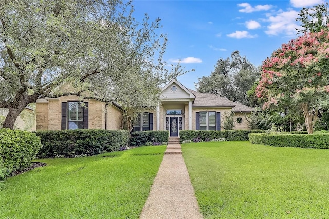 3110 Barton Point Dr, Austin, TX 78733 - view of front of home featuring a front lawn, brick siding, and french doors