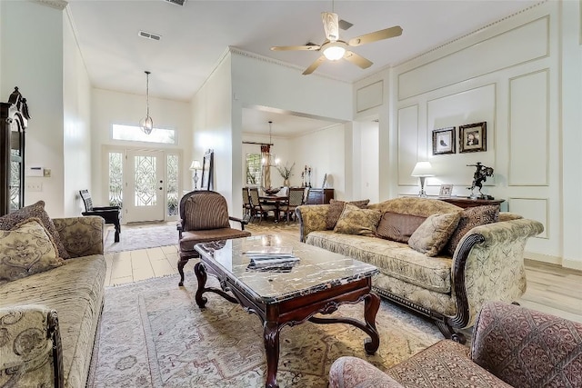 3110 Barton Point Dr, Austin, TX 78733 - living room featuring light wood-type flooring, healthy amount of natural light, ornamental molding, and a ceiling fan