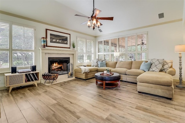 3110 Barton Point Dr, Austin, TX 78733 - living area with ceiling fan, light wood-type flooring, a tiled fireplace, and ornamental molding