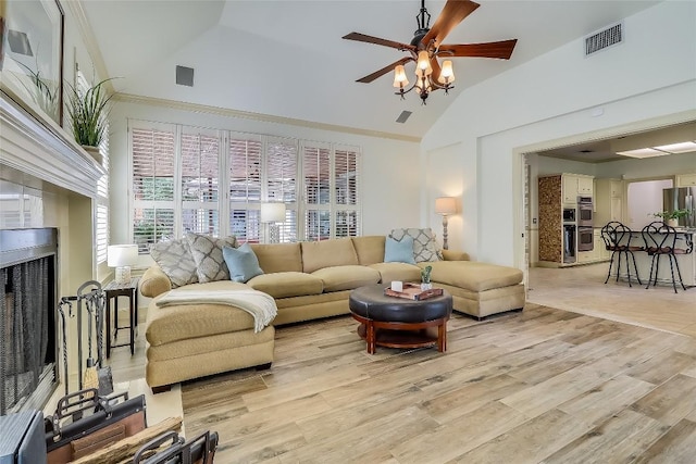 3110 Barton Point Dr, Austin, TX 78733 - living area with lofted ceiling, ceiling fan, light wood-style floors, and a fireplace