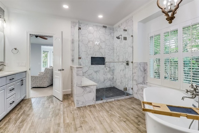 3110 Barton Point Dr, Austin, TX 78733 - ensuite bathroom with a freestanding bath, a marble finish shower, vanity, wood finished floors, and crown molding