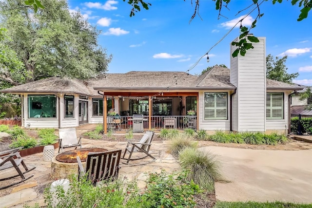 3110 Barton Point Dr, Austin, TX 78733 - rear view of house featuring a fire pit, a chimney, a patio area, and roof with shingles