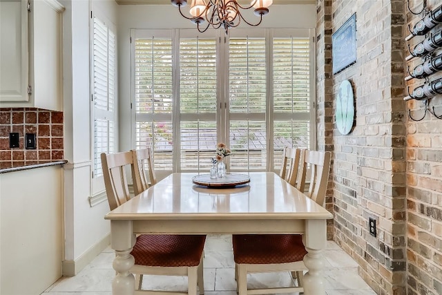 3110 Barton Point Dr, Austin, TX 78733 - dining space featuring a chandelier, plenty of natural light, and brick wall