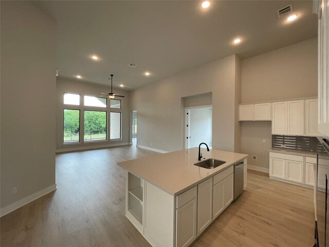 1824 Camay St, Leander, TX 78641 - kitchen featuring stainless steel dishwasher, a ceiling fan, white cabinets, light wood finished floors, and recessed lighting