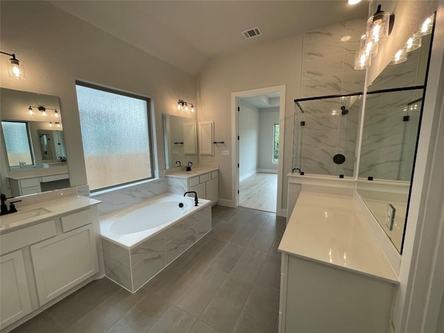 1824 Camay St, Leander, TX 78641 - bathroom with a marble finish shower, vaulted ceiling, a garden tub, and two vanities
