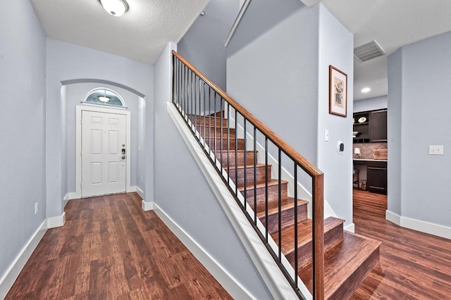 204 Parable Cv, Pflugerville, TX 78660 - entrance foyer with dark wood finished floors and stairway