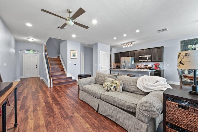 204 Parable Cv, Pflugerville, TX 78660 - living area with ceiling fan, stairway, dark wood finished floors, and recessed lighting