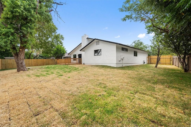 5806 Burnhill Dr, Austin, TX 78745 - rear view of house with a chimney and a fenced backyard