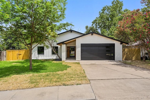5806 Burnhill Dr, Austin, TX 78745 - view of front of home featuring an attached garage, brick siding, and concrete driveway