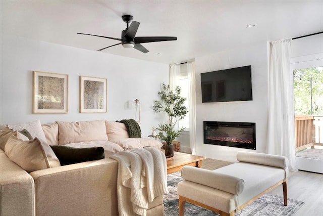 5806 Burnhill Dr, Austin, TX 78745 - living area featuring ceiling fan, wood finished floors, and a glass covered fireplace