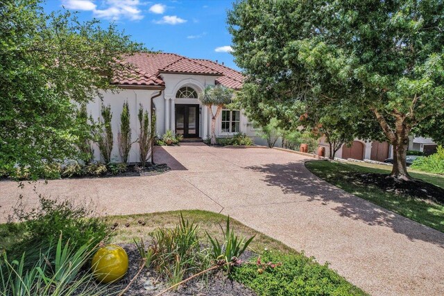 6717 Valburn Dr, Austin, TX 78731 - mediterranean / spanish-style house featuring french doors, stucco siding, and a tile roof