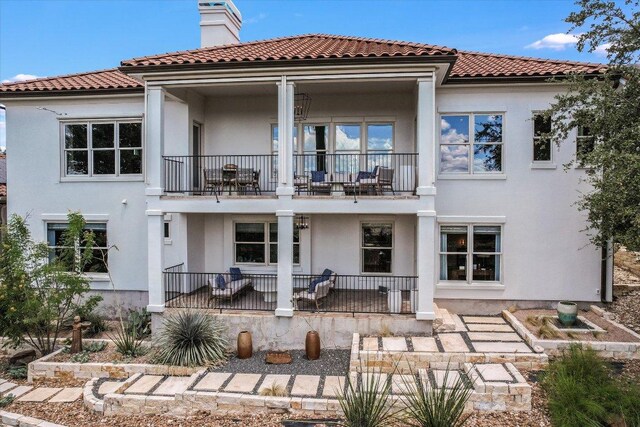 6717 Valburn Dr, Austin, TX 78731 - rear view of house featuring a balcony, stucco siding, a chimney, and a porch