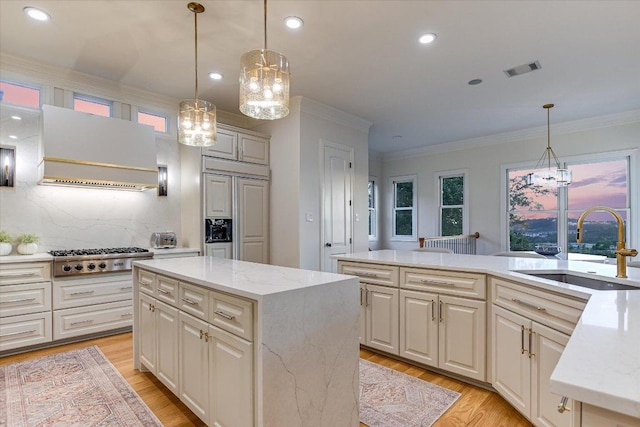 6717 Valburn Dr, Austin, TX 78731 - kitchen with premium range hood, a chandelier, stainless steel gas cooktop, paneled built in fridge, and crown molding