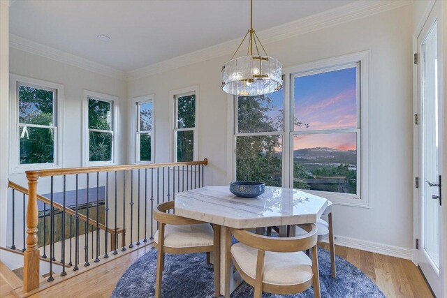 6717 Valburn Dr, Austin, TX 78731 - dining space featuring a chandelier, healthy amount of natural light, light wood-style flooring, and crown molding