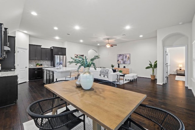 19825 Rhiannon Ln, Pflugerville, TX 78660 - dining area featuring ceiling fan, dark wood-type flooring, recessed lighting, and arched walkways