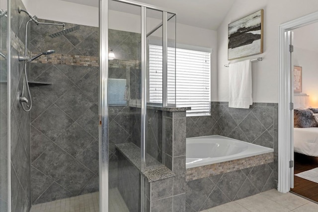 19825 Rhiannon Ln, Pflugerville, TX 78660 - ensuite bathroom featuring a bath, a shower stall, lofted ceiling, and tile patterned flooring