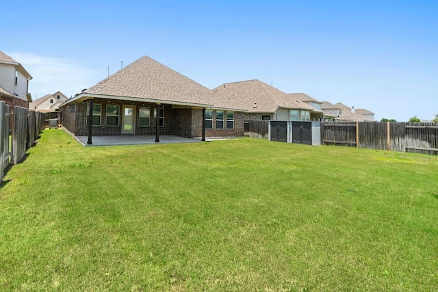 19825 Rhiannon Ln, Pflugerville, TX 78660 - rear view of property with a fenced backyard, a patio, brick siding, and a shingled roof