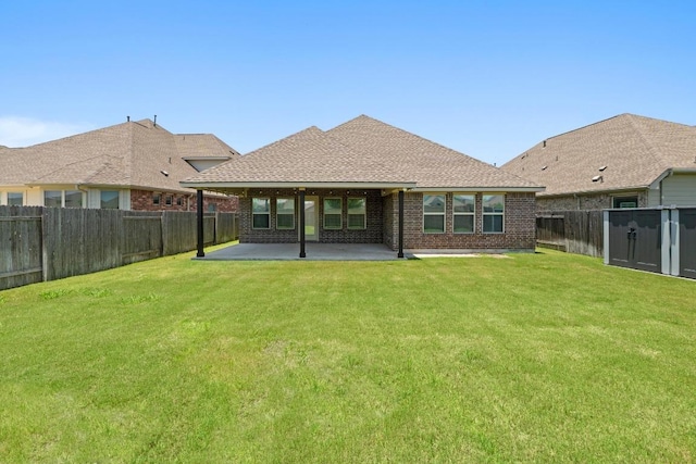 19825 Rhiannon Ln, Pflugerville, TX 78660 - back of property featuring a fenced backyard, a patio, brick siding, and roof with shingles