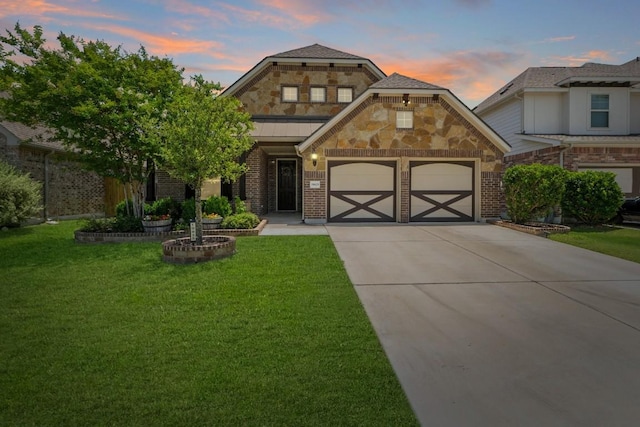 19825 Rhiannon Ln, Pflugerville, TX 78660 - view of front of property featuring driveway, a garage, a lawn, brick siding, and stone siding