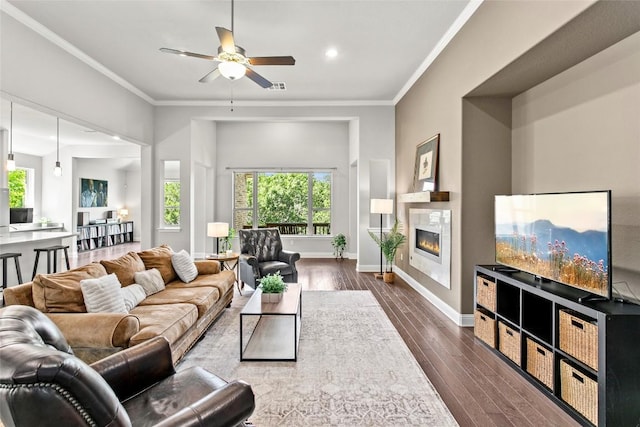 226 Brentwood Dr, Austin, TX 78737 - living area with plenty of natural light, dark wood-style flooring, a ceiling fan, ornamental molding, and a tile fireplace
