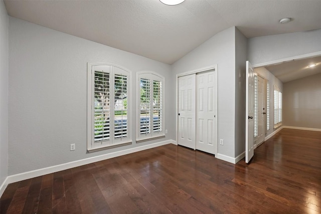 1704 Big Bend Dr, Cedar Park, TX 78613 - unfurnished bedroom with lofted ceiling, hardwood / wood-style floors, a closet, and french doors