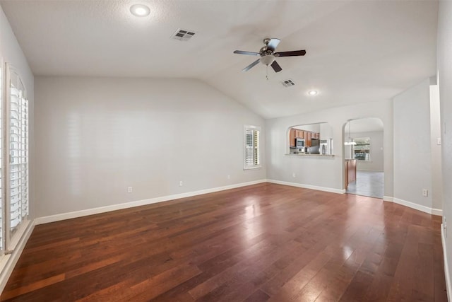 1704 Big Bend Dr, Cedar Park, TX 78613 - unfurnished living room with ceiling fan, wood-type flooring, lofted ceiling, and arched walkways