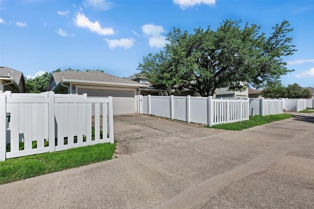 1704 Big Bend Dr, Cedar Park, TX 78613 - view of side of property with a fenced front yard, concrete driveway, and an attached garage