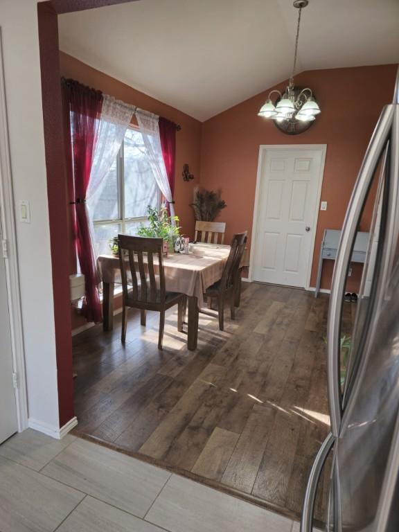 211 Valley Run Trl, Elgin, TX 78621 - dining space with a chandelier, lofted ceiling, and wood finished floors