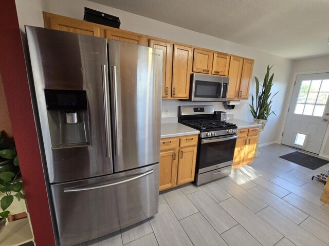 211 Valley Run Trl, Elgin, TX 78621 - kitchen featuring stainless steel appliances, light countertops, and wood finish floors