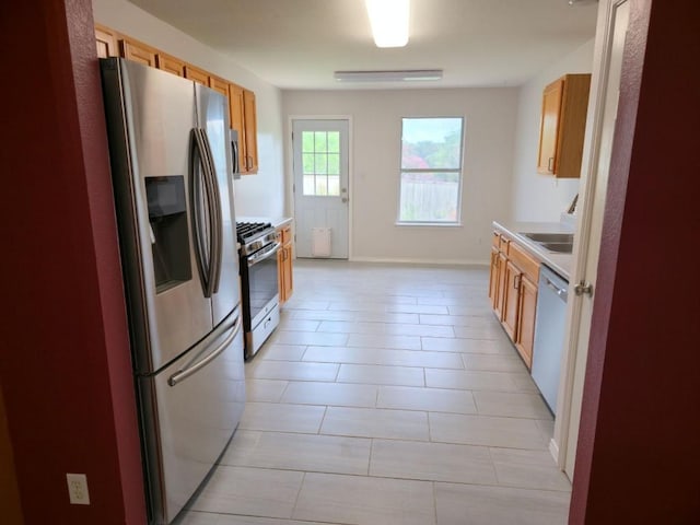 211 Valley Run Trl, Elgin, TX 78621 - kitchen with appliances with stainless steel finishes, light countertops, and light tile patterned flooring