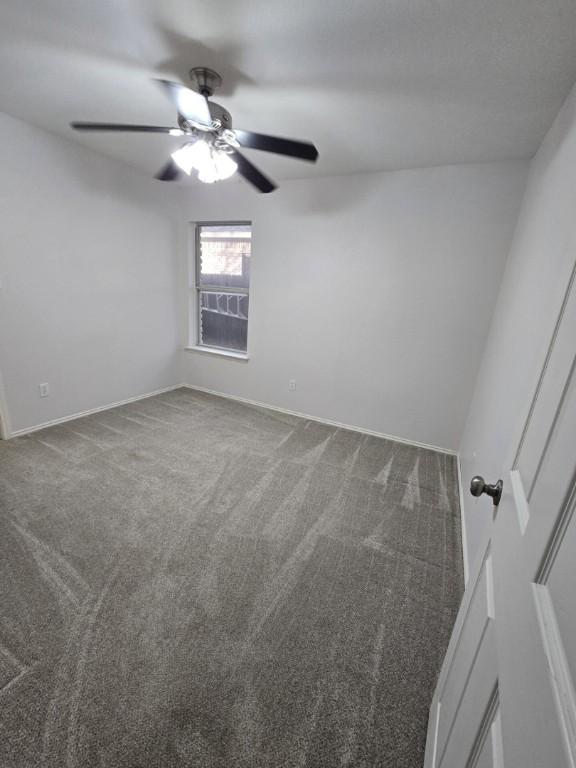 211 Valley Run Trl, Elgin, TX 78621 - spare room featuring dark carpet and ceiling fan