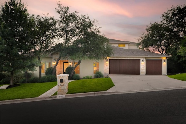 4001 Firstview Dr, Austin, TX 78731 - obstructed view of property with a garage, stone siding, concrete driveway, and a front lawn