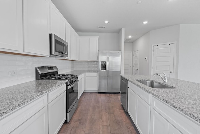 2800 Joe Dimaggio Blvd Unit 84, Round Rock, TX 78665 - kitchen featuring stainless steel appliances, dark wood-style flooring, white cabinets, recessed lighting, and light stone counters