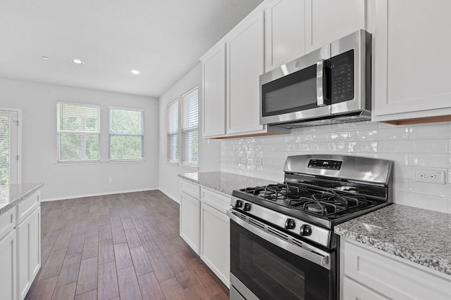 2800 Joe Dimaggio Blvd Unit 84, Round Rock, TX 78665 - kitchen featuring appliances with stainless steel finishes, dark wood-style floors, tasteful backsplash, white cabinetry, and recessed lighting