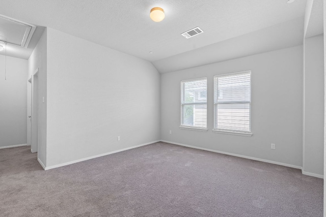 2800 Joe Dimaggio Blvd Unit 84, Round Rock, TX 78665 - carpeted empty room with attic access and vaulted ceiling