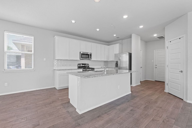 2800 Joe Dimaggio Blvd Unit 84, Round Rock, TX 78665 - kitchen featuring stainless steel appliances, wood finished floors, white cabinetry, and recessed lighting