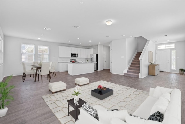 2800 Joe Dimaggio Blvd Unit 84, Round Rock, TX 78665 - living room featuring stairs, light wood finished floors, and recessed lighting