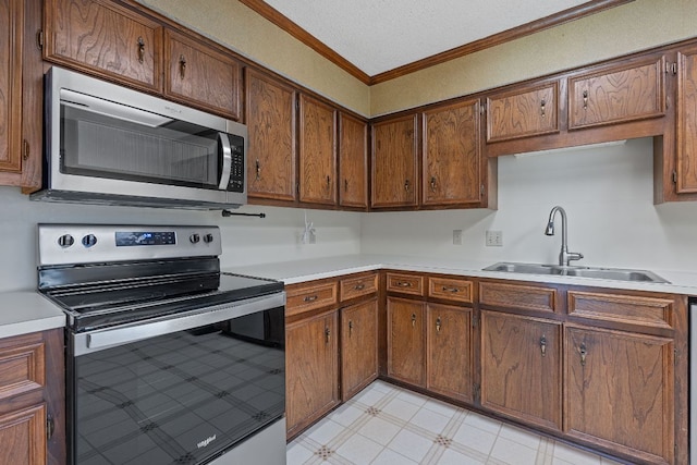 13212 Broadmeade Ave, Austin, TX 78729 - kitchen with appliances with stainless steel finishes, crown molding, light countertops, light floors, and brown cabinetry