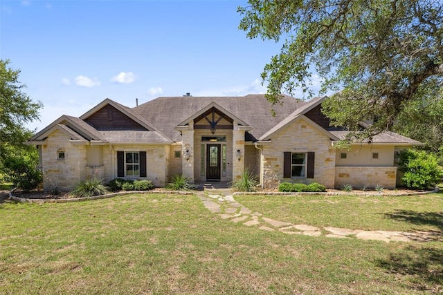 306 Anns Way, Blanco, TX 78606 - view of front of house featuring stone siding, a front yard, and a shingled roof
